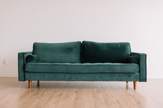 Furniture loans green couch on timber flooring