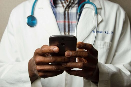 Medical loans doctor wearing stethoscope holding phone
